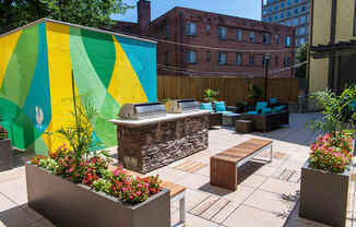 a patio with furniture and a large mural
