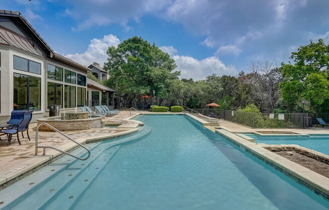 a swimming pool with a house in the background
