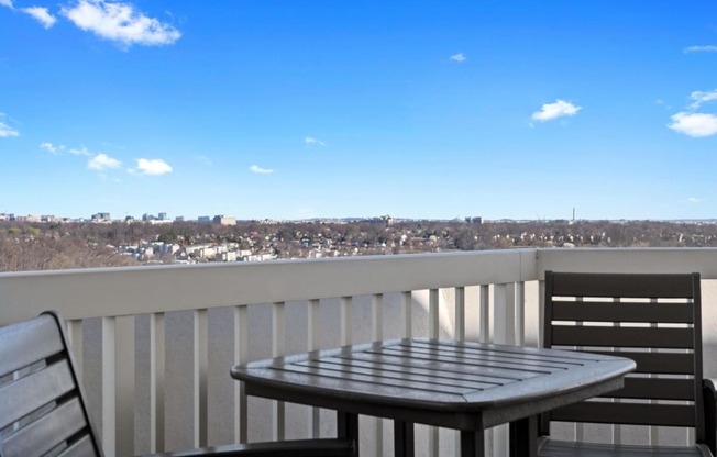 a view of the city from a balcony with a table