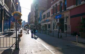 a city street with people walking down the sidewalk at East 4th Street, Cleveland, Ohio