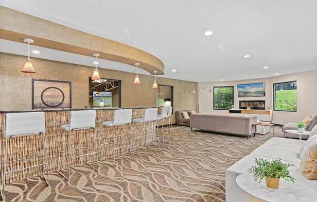 A room with a patterned carpet and a white table with a plant on it.