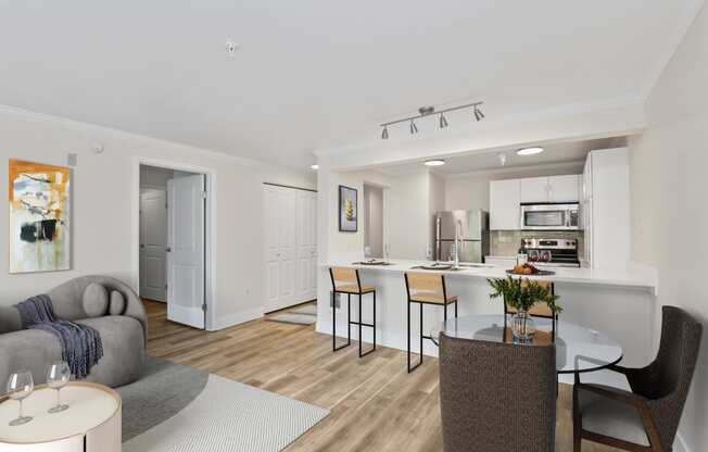 a living room with a kitchen and dining area