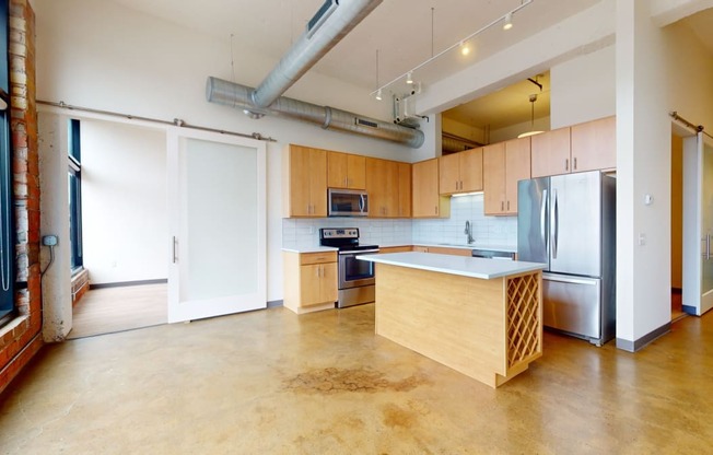 a kitchen with wood cabinets and stainless steel appliances