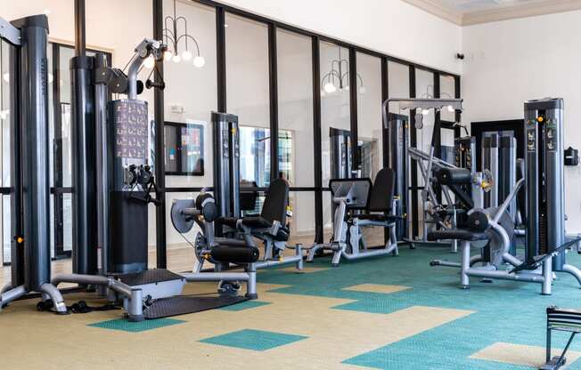 a fitness room with weights and other exercise equipment