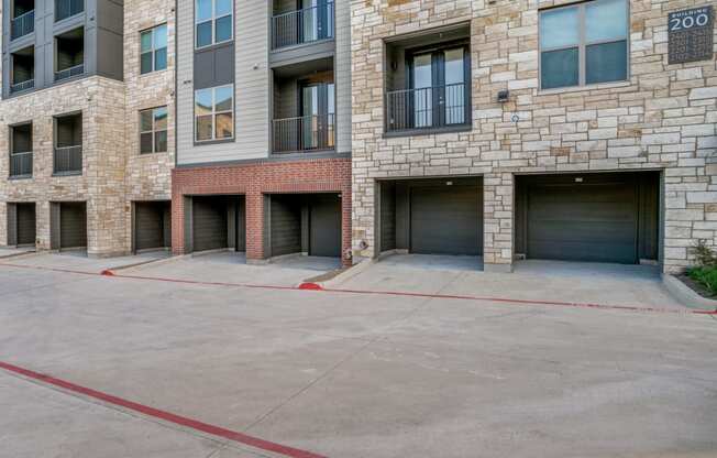 an empty parking lot in front of an apartment building