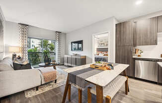 Model Dining Room and Living Room Area with Wood-Style Flooring at Glen 91 Apartments located in Glendale, AZ.