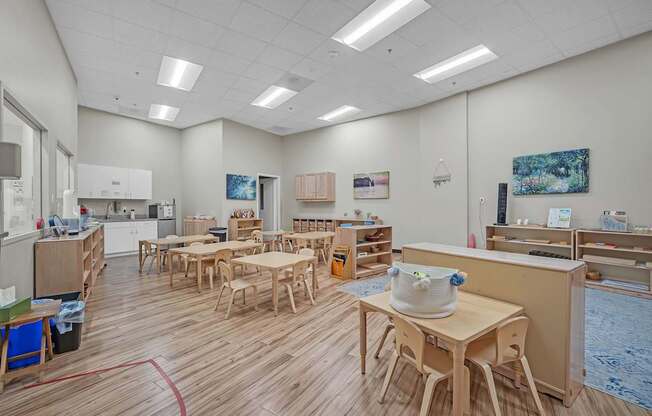 A room with wooden floors and tables.