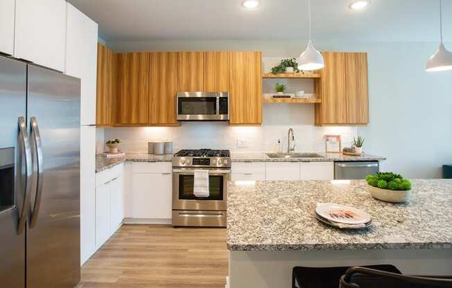 a modern kitchen with stainless steel appliances and granite counter tops