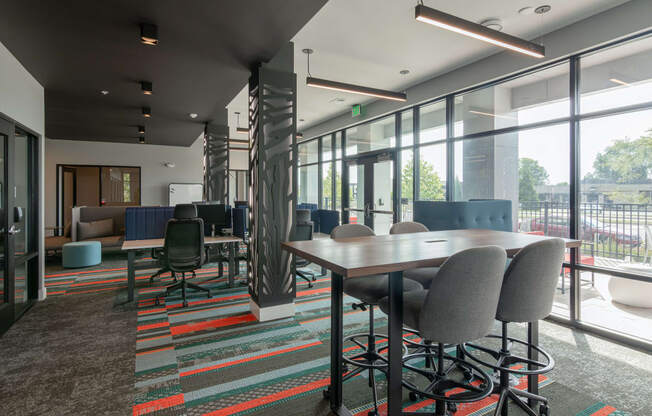 a large room with tables and chairs and large windows