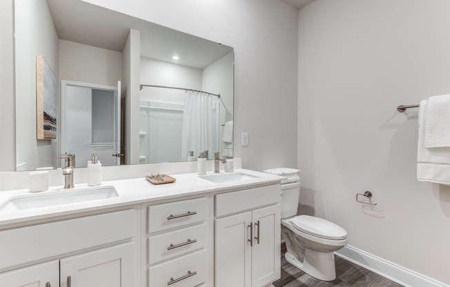 Indulge in tranquility with the serene bathrooms of these townhomes, featuring the convenience of dual sinks.
