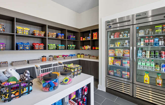 A refrigerator and freezer are on the right, and a shelf with many items is on the left.