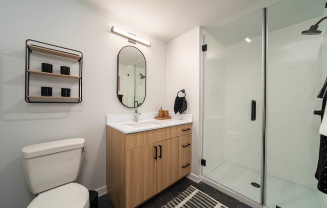 a bathroom with a toilet sink and shower