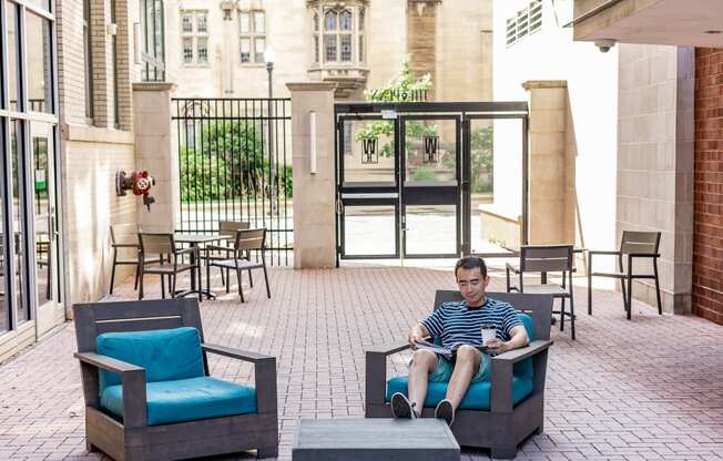 a man sitting in a chair on a patio