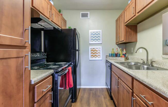 a kitchen with stainless steel appliances and wooden cabinets