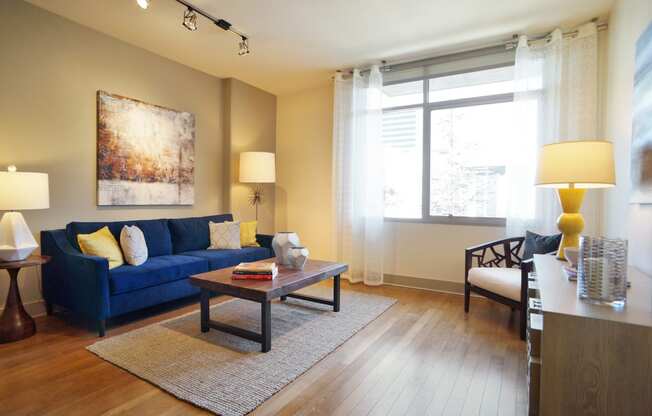 a living room with a blue couch and a coffee table