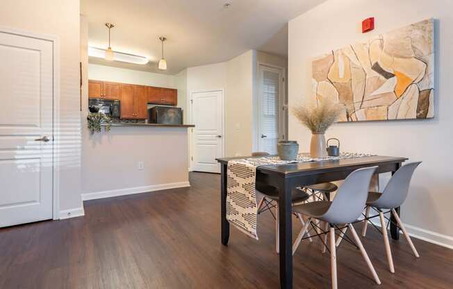 a kitchen and dining room with a table and chairs