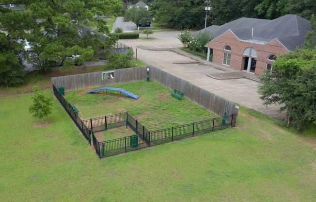 a backyard with a grassy area and a trampoline