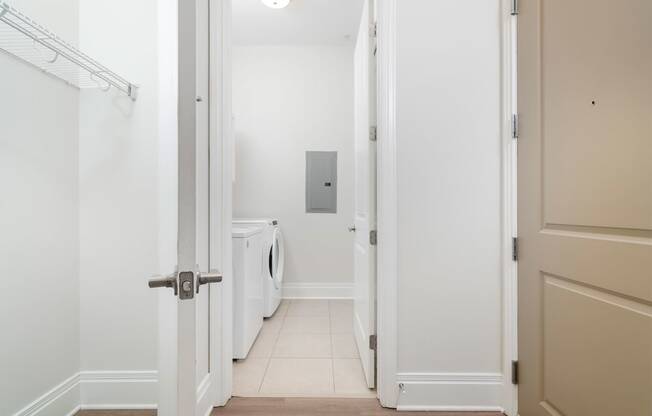 a laundry room with a washer and dryer in a 555 waverly unit