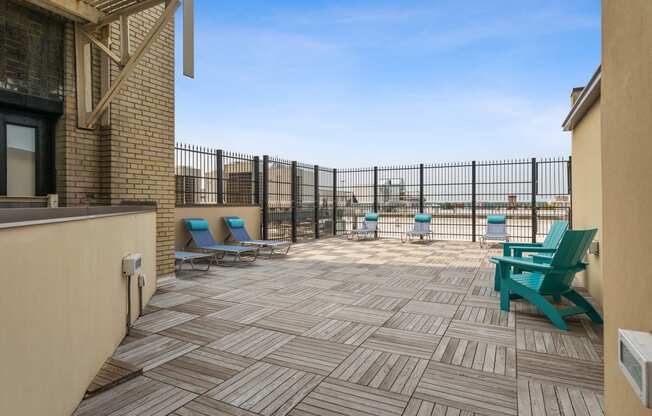 a patio with chairs and a grill at the villas at falling waters in west omaha