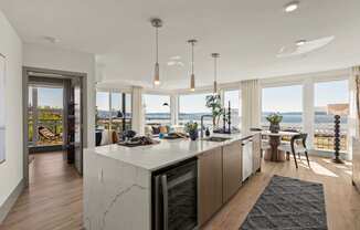 Vela Apartments kitchen and living room with a view of the water