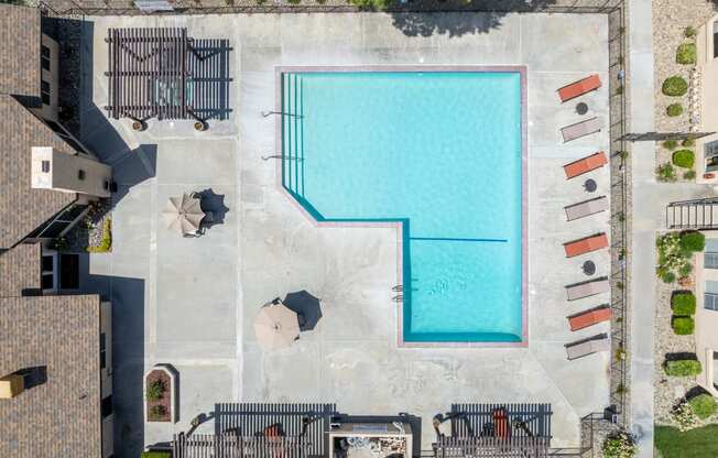 arial view of a swimming pool in a building with umbrellas