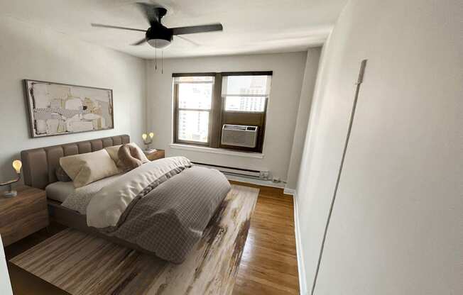 a bedroom with a bed and a ceiling fan