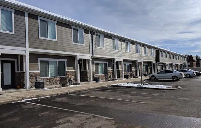 a row of apartment buildings in a parking lot