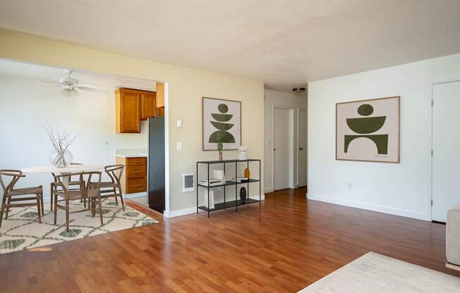 A living room with a dining table and chairs.