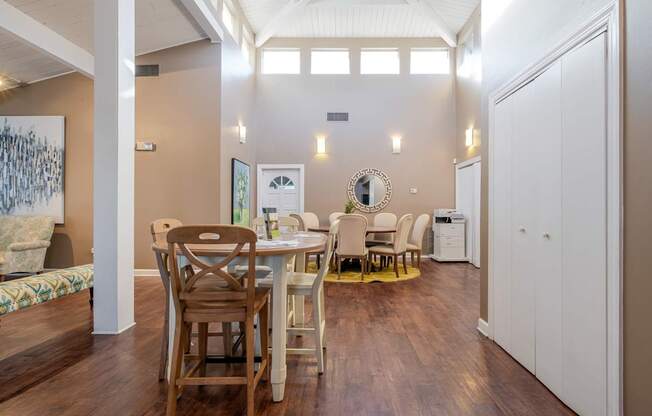 A dining room with a white table and chairs.