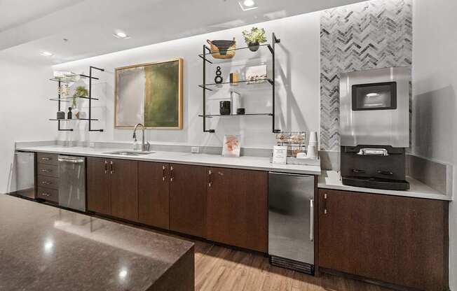A modern kitchen with dark wood cabinets and stainless steel appliances.