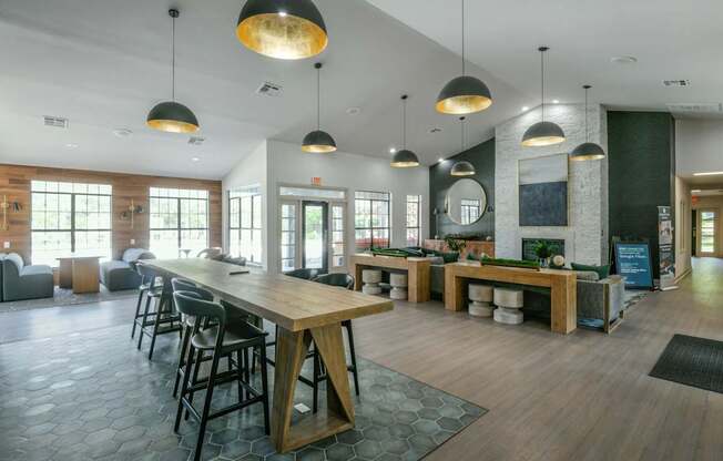 A large room with a long wooden table and chairs.