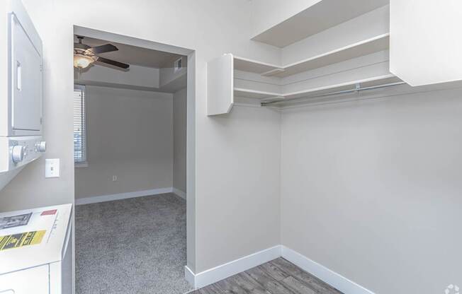 A room with a ceiling fan and a window.