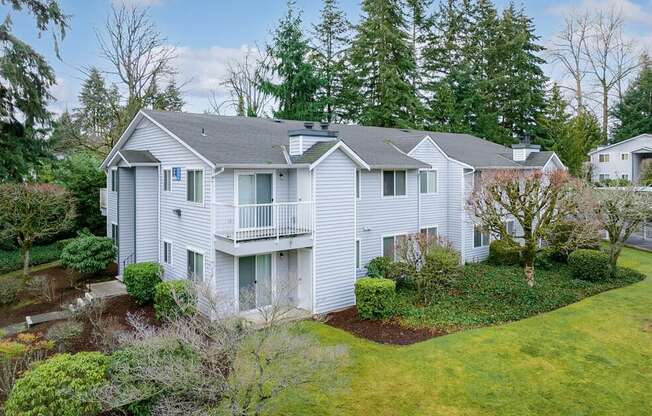 a white house with a yard and trees at Springfield, Washington, 98055 