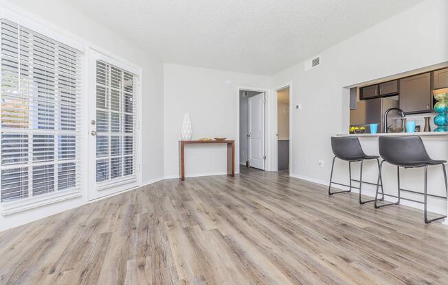 a living room filled with furniture and a large window