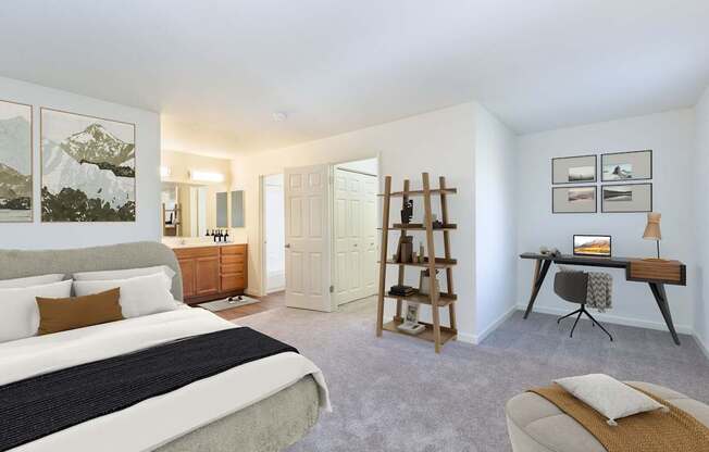 A bedroom with a large bed and a desk with a chair.