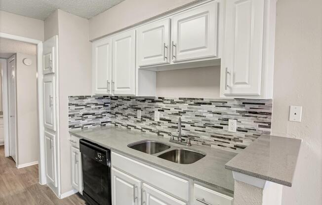 a kitchen with a stove sink and refrigerator