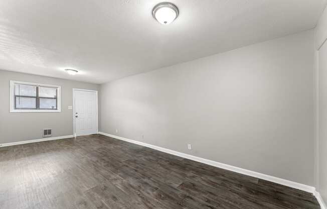 a bedroom with hardwood floors and grey walls  at Balfour 296, Lilburn, GA