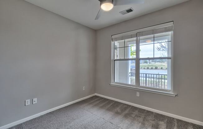 an empty living room with a large window at Nexus at Sandhill, South Carolina