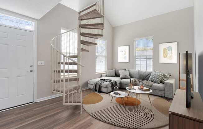 a spiral staircase in a living room with a couch at Orleans Apartments, Columbus, Ohio