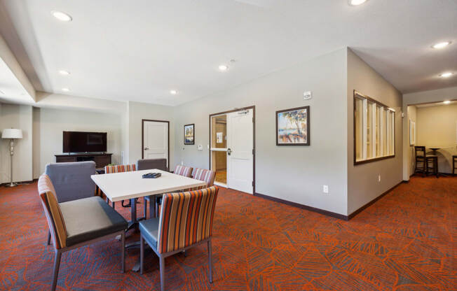 a conference room with a table and chairs and a piano