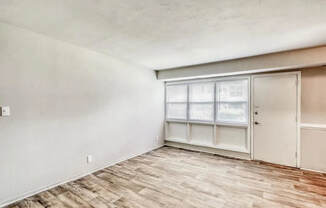 an empty living room with a window and a door at Gates of West Bay, Virginia