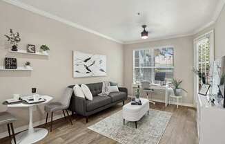 Windsor living room with a sofa, rug, and large window at Encore at Buckingham Apartments in Richardson, TX