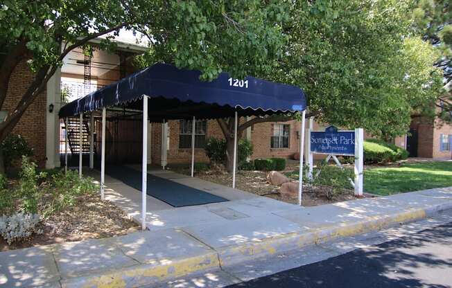 a blue awning in front of a brick building