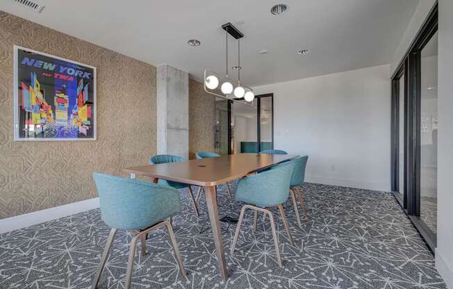A conference room with a wooden table and blue chairs.