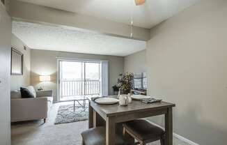 an open living room and dining room with a table and chairs