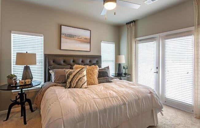 Furnished bedroom with ceiling fan at Lullwater at Blair Stone apartments for rent in Tallahassee, FL