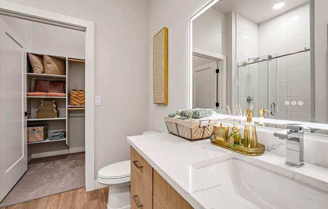 A bathroom with a white sink and a toilet.