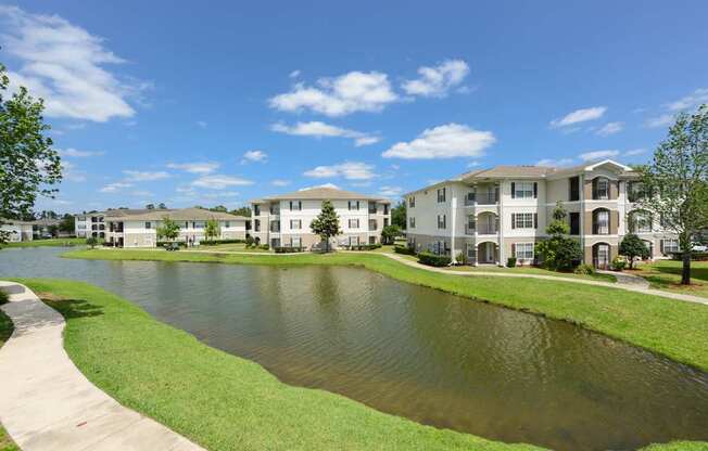 A large body of water in front of apartment buildings.