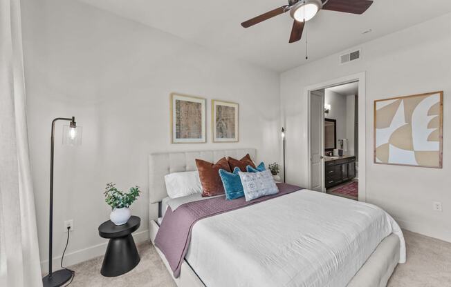 a bedroom with a bed and a ceiling fan